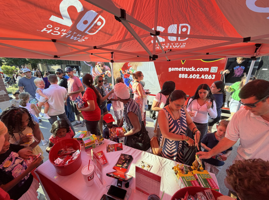 GameTruck theater and Mott's table at a National Night Out community event